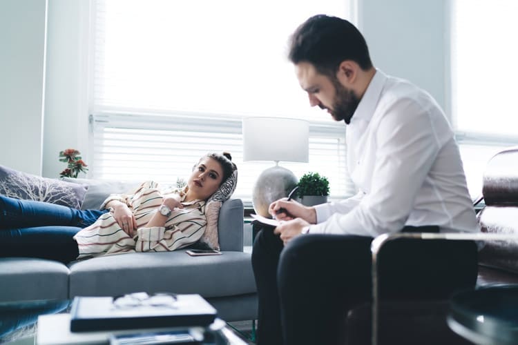 Cognitive Behavioral Therapy, pretty young woman lying on couch in therapy session with attractive man - Cognitive-Behavioral Therapy, Behavioral Cognitive Therapy